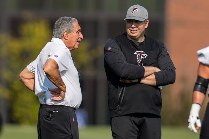 Jul 29, 2021; Flowery Branch, GA, USA; Atlanta Falcons team owner Arthur Blank (left) talks with head coach Arthur Smith on the field during the first day of training camp at the Atlanta Falcons Training Facility.